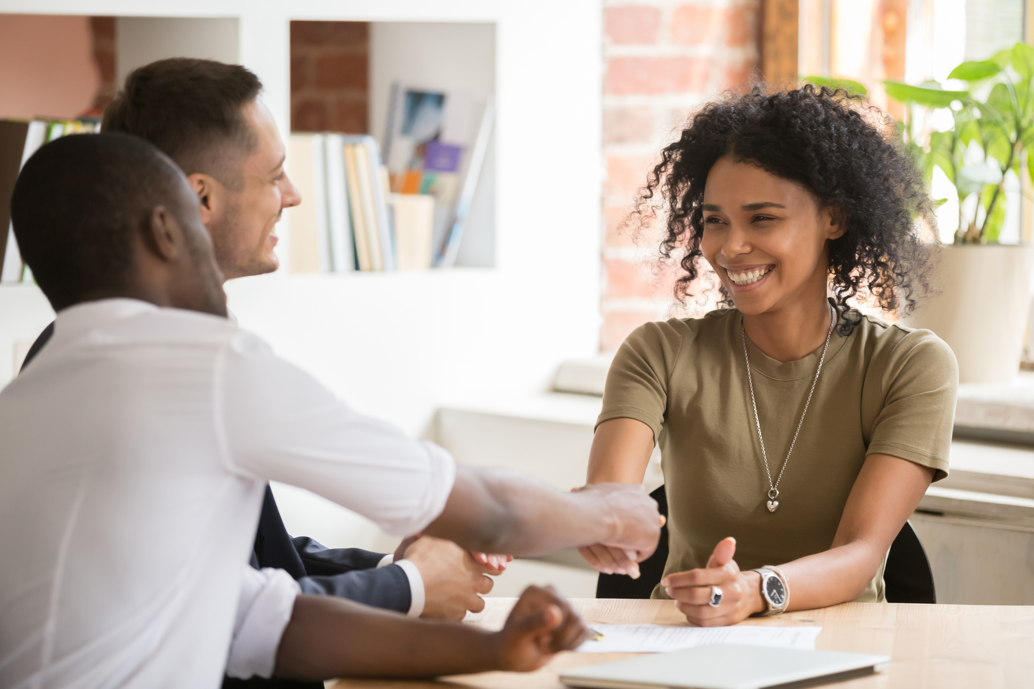 Happy female african vacancy candidate shaking hand of hr manager retained-header